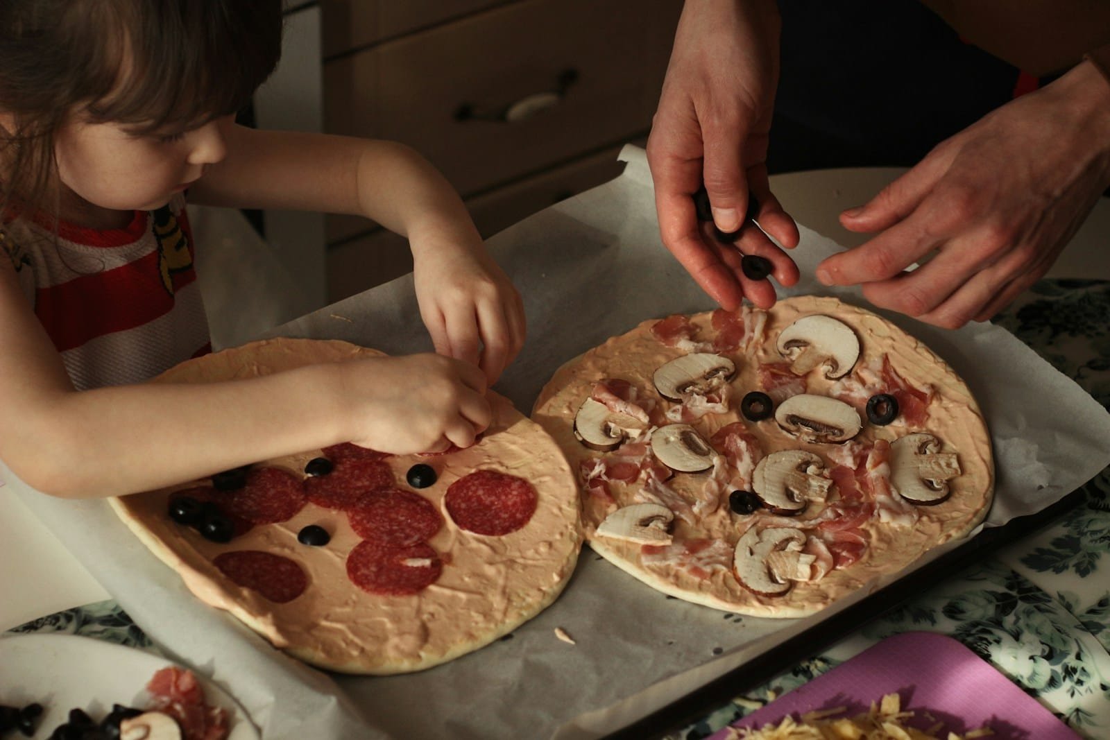 person holding pizza with pepperoni and cheese